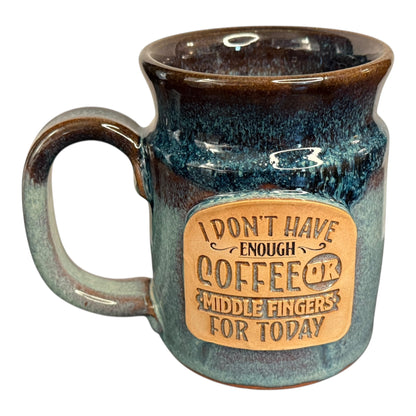 The Middle Finger Mug from Legendary Aviation Coffee resting on a table – 20oz handcrafted ceramic mug made by Sunset Hill Stoneware in Rockwall, Texas.