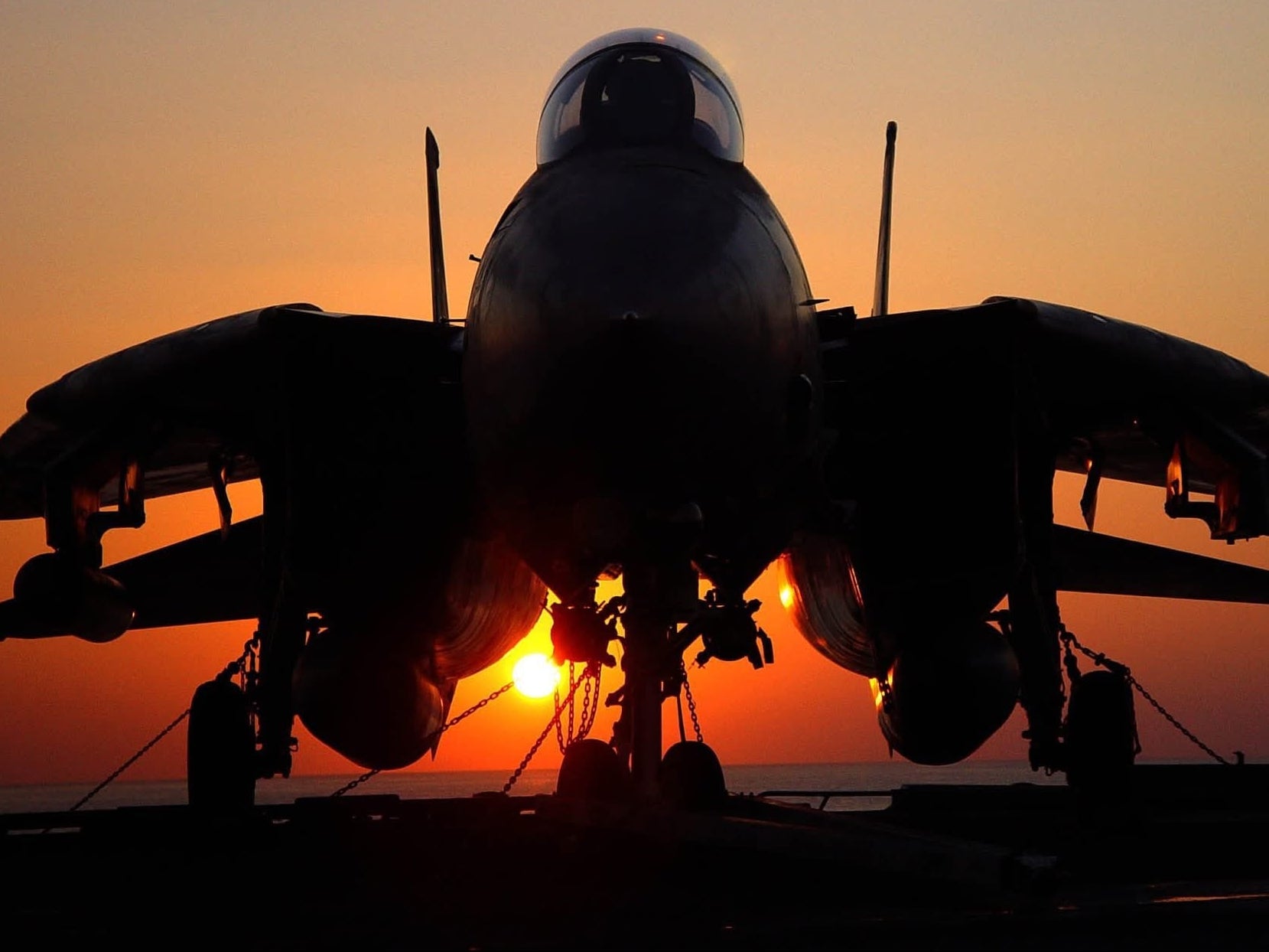 Legendary Aviation Coffee, Rockwall Texas, Silhouette of a fighter jet against a sunset sky